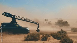 The camera breaks. The movie camera attached to the car falls to the ground in the desert. The camera is shattered. Movie production. An extreme incident. Crash. The difficulties of filmmaking.