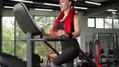Woman training legs buttocks stair step exercise machine gym Athlete...