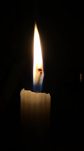 Beautiful White Candle Flame in Dark Background