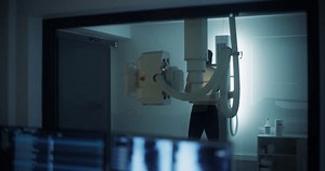 Asian Female Doctor Inspecting X-ray Scans on an Advanced Diagnostic Application in a Hospital in a Radiology Medical Office. Radiographer Working on a Computer, Looking at Medical Images
