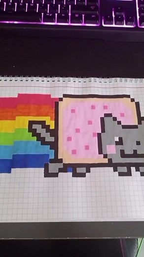 Drawing a Rainbow Cat in Pixel Art on Checkered Paper