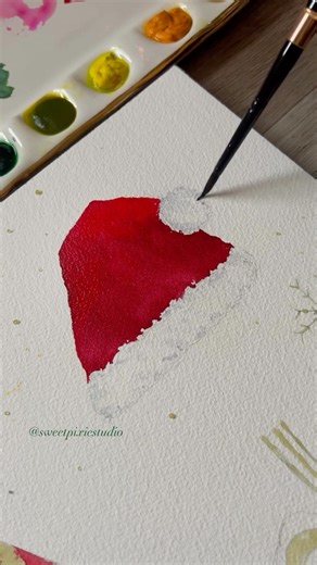 𝐎𝐥𝐢𝐯𝐢𝐚 - SweetPixieStudio on Instagram: "I really enjoy painting with red, there is so much depth to this colour, I like to add blue or green to change the tone. For this little Santa hat I used indigo to darken up my red, then I used that same indigo very diluted to add shadows on the white paper to make it look nice a fluffy. Using @artphilosophyco Artist Grade Watercolour tubes, shop the link in @sweetpixiestudio bio for a special discount!"
