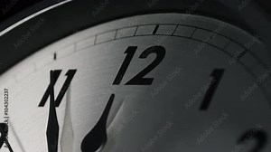 Slow zoom into a clock face as 12 o'clock approaches, 11:55