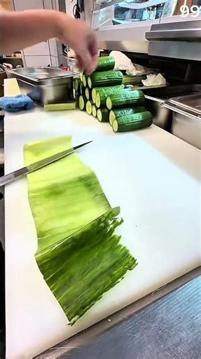 Cucumber peeled into delicate sheet on white board