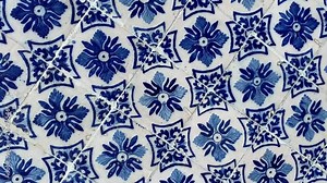 Abstract rotating background of painted ceramic tiles in blue and white