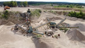Download Aerial view of conveyor system of opencast limestone mining quarry. for free
