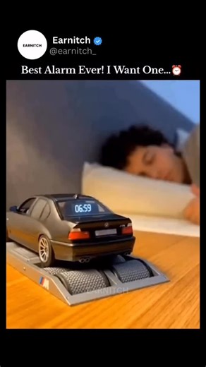 EARNITCH on Instagram: "This video features a concept of a BMW M5 (E39) Alarm Clock that simulates a high-performance engine “dyno” run to wake you up. As the clock strikes 7:00 AM, the miniature silver sedan—modeled after the legendary V8-powered M5-begins revving its engine, spinning its wheels on the rollers of a scale dynamometer, and even shooting blue flames from the exhaust. The audio is a dubbed recording of a real E39 M5 engine, creating the ultimate wake-up call for car enthusiasts. Ho