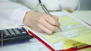 Woman physician filling out papers, calculating patient's health insurance costs