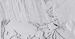 Very high-altitude overflight aerial of iceberg calving, Pine Island Glacier, Antarctica. Clip loops and is reversible. Elements of this image furnished by USGS/NASA Landsat