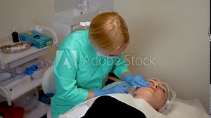 Doctor cosmetologist makes Botulinum Toxin injection. Procedure for tightening and smoothing wrinkles. Rejuvenating facial injections. Female enjoying facial treatment, moisturizing and rejuvenating
