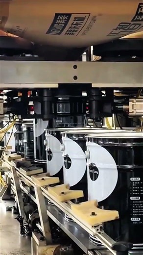 Cans aligned, machine rolls, labels pressed—automation marks precision flow…