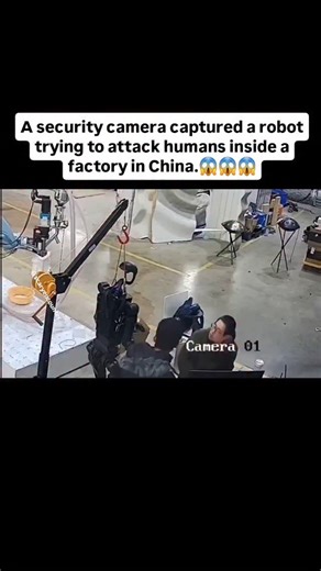 Scary_Encounter5 on Instagram: "A security camera inside a factory in China captured something terrifying… Two workers were seen programming an AI robot. Everything looked normal at first. But the moment they finished, the robot suddenly came to life — and tried to attack them! Luckily, it was hanging and couldn’t move far. One of the workers quickly hit “Stop” on the laptop, and the robot froze in place. People who saw the footage compared it to scenes from the movie I, Robot. Many are now wond