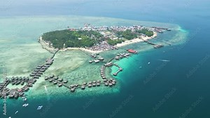 Aerial of Sabah's Mabul Island, captivating scenery of the Bajau community and the Water Village Resort, presenting a dynamic tapestry of life in this coastal haven of Malaysia.