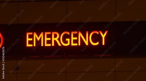 Emergency Department Service Red Sign on Hospital Building at Night