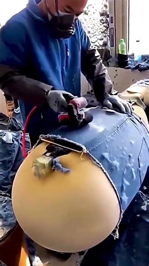 Distressing process of jeans in a garment factory