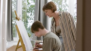 Free stock video - Mother and daughter painting on canvas