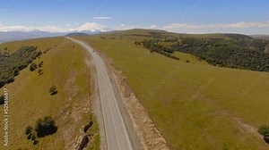 Aerial landscape view of the mount Elbrus - the highest peak in Europe. Top view of the field, winding roads and Caucasus mountains.
