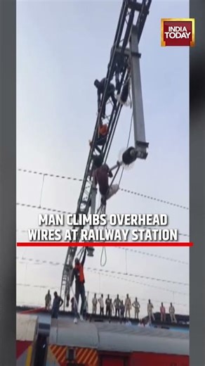 Maharashtra Railway Chaos: Man Climbs Gantry at Manmad Station #maharashtra #viralvideo