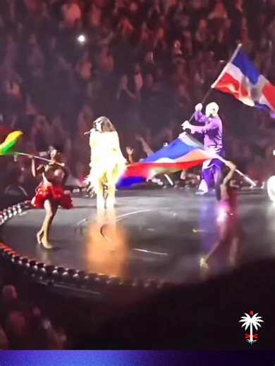 PEOPLE | Just days after the Haitian flag was proudly waved during Bad Bunny’s Super Bowl halftime show, it appeared again on a major stage, this time at Cardi B’s Little Miss Drama Tour launch on February 11 at Acrisure Arena in Palm Desert, California. During her performance of “Bodega Baddie,” Latin flags filled the stage, and among them, the blue and red of Haiti stood tall. The moment reflects more than symbolism. Cardi B, born Belcalis Almánzar to a Dominican father and Trinidadian mother,