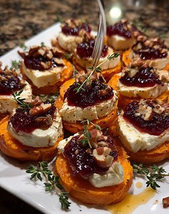 Sweet Potato Rounds with Brie, Cranberry & Pecans Ingredients: 2 large sweet potatoes, peeled and sliced into ½-inch thick rounds 2 tablespoons olive oil ½ teaspoon salt ½ teaspoon black pepper 6 ounces Brie cheese, sliced into small pieces ½ cup cranberry sauce (or whole cranberries) ½ cup pecans, chopped and lightly toasted 1 tablespoon honey (optional drizzle) Fresh thyme leaves (for garnish) Directions: 1. Preheat oven to 400°F (200°C) and line a baking sheet with parchment paper. 2. Arrange