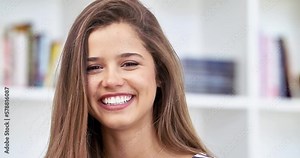 Portrait, student or winking in school, university or college campus library in flirty, fun or playful facial expression. Happy, smile or woman face in wink emoji and laughing at funny joke or comedy