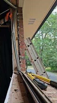 Removing an aluminum casement window from a brick house