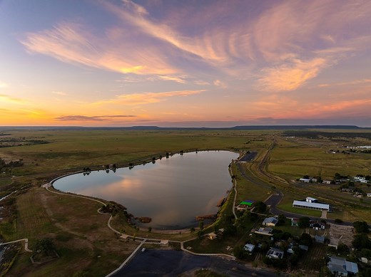 Need a break from the heat? Head to the Hughenden Recreational Lake! You can swim, kayak, or paddleboard in the cool water. It's also a top spot for fishing—the lake is stocked with thousands of fish and yabbies. If you prefer to stay on land, grab a coffee from The Golden Lab and watch the sunrise, or walk and cycle the scenic trails. #visithughenden #hughenden #overlandersway #outbackqueensland #thisisqueensland #queensland #outback #australia #travelaustralia | Visit Hughenden