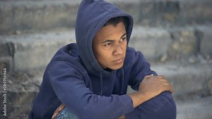 Depressed homeless teenager sitting street alone, dysfunctional family, crisis