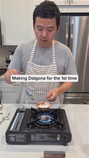 Daniel & Eunice on Instagram: "Dalgona is made with two simple ingredients: sugar and baking soda. Making it was a lot harder than we thought. People on Youtube made it seem easy, what they didn't mention is how easily the sugar sticks to the surfaces. Later I realized I should have sprinkled sugar all over the surfaces because that's what the street vendors do to avoid the stick. I used to eat this growing up in Korea, and this is what I vaguely remember. If you cut out the shapes with no error