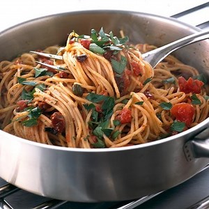 Pasta with anchovies, tomatoes, olives and garlic
