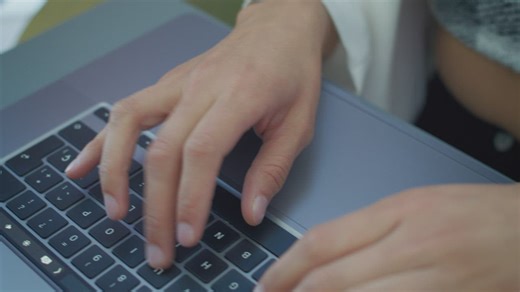 Hands of a woman typing on a laptop keyboard - Free Stock Video