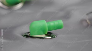 Fitting the pneumatic pipe to the plastic compressed air valve by hand. Industrial engineering equipment close up