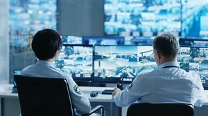 Security Team Monitors Many CCTV Surveillance Screens