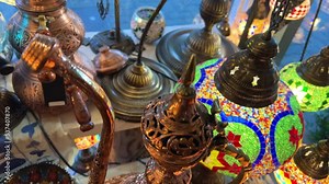 Turkish lamps have a multi-colored mosaic on them, they glow from the middle, shining and shimmering Nearby are Aladdin's lamps, various painted plates. The shop is lovely Showcase of vintage Turkish