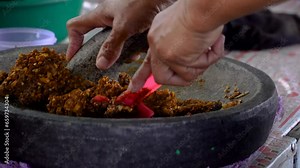 grinding brown sugar in a mortar