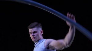 Muscular Circus artist spinning on a Cyr wheel in slow motion. Concept of movement, motion and balance