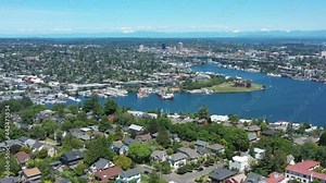 Drone flying over upper Queen Anne in Seattle with views of Lake Union, Gas Works Park, University of Washington and Fremont on a clear sunny day.