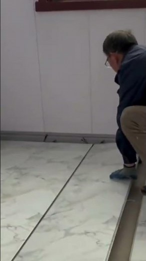 the process of installing long board panels on the floor in a building room #construction #shorts