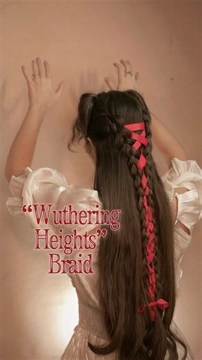 Cathy “WUTHERING HEIGHTS” Hair Tutorial♥️ Here’s how to recreate Cathy’s iconic ribbon corset braids from Wuthering Heights (2026) on yourself! Step-by-step: • Leave out a small front section for mini victory rolls • Start with 3 stitches of Dutch braid, then continue into a regular braid on either side • Begin criss-crossing ribbon (under & over) to create a corset pattern • Bind the braids closer together: wrap ribbon over each braid loop and cross at the back, pulling tighter to create 1 brai