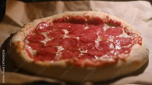 Time lapse video of baking pizza with salami pepperoni in a home electric oven. Pizza with salami in hot oven close up. Time lapse. UHD 4k video