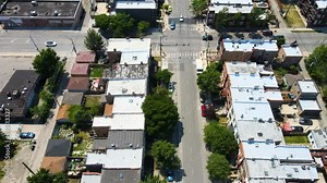 aerial overhead drone view of a Chicago urban neighborhood during the afternoon . the residential area is has colorful buildings great for a background