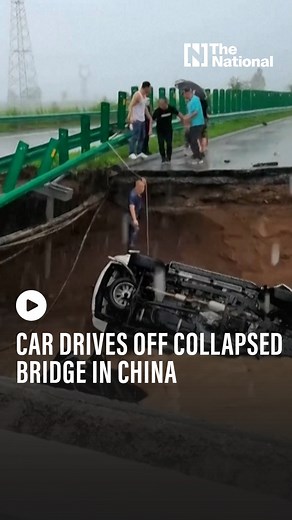A car drives off a bridge that collapsed due to the rains and floods caused by Typhoon Doksuri in China. | The National