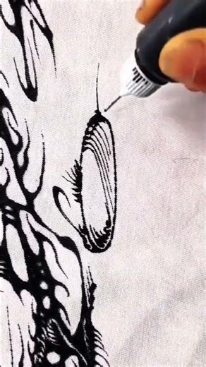 Drawing intricate black line art on white fabric with black marker