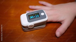 Child boy using pulse oximeter for oxygen blood saturation measurement,covid19 pandemic disease