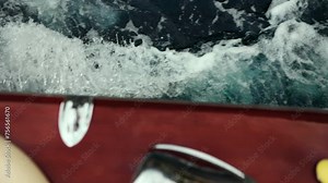 Slow motion of a boat sailing at speed in blue water