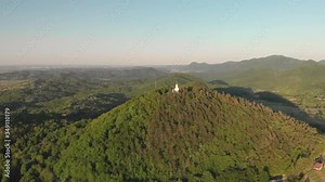 Old christian sanctuary chapel on the top of hill in the middle of a beautiful green forest. Aerial cinematic footage