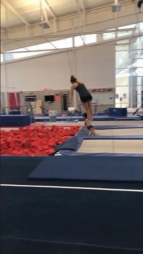Two gymnasts are playing around in the foam pit!