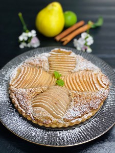 Pear Frangipane Tart Continuing our international dishes with desi touch - the journey goes to France. Sharing the famous Pear Frangipane Tart recipe in the eggless version. Ingredients : 2 cup(200 gm) plain flour (maida) 100 gm butter A pinch of salt 7 tbs caster sugar 1 tsp vanilla essence 4-6 tbs chilled milk 2 tbs milk (room temperature) 1ltr water 4 tbs water 1/2 sugar A piece of cinnamon stick Some lemon rind 2 pears Lime juice (to squeeze on pear) 140 gm almond flour 2 tbs flaxseeds 1 tsp