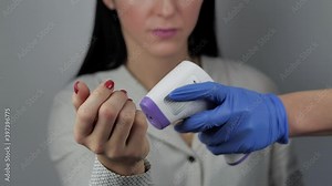 Covid-19 temperature checkpoint. Scientist in protective suit checking screening body temperature of woman, detecting fever symptoms taking female away suspecting him to be infected by coronavirus