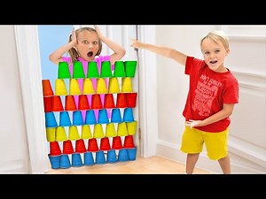 Chris and Alice playing with colored cups learning how to teamwork and respect others